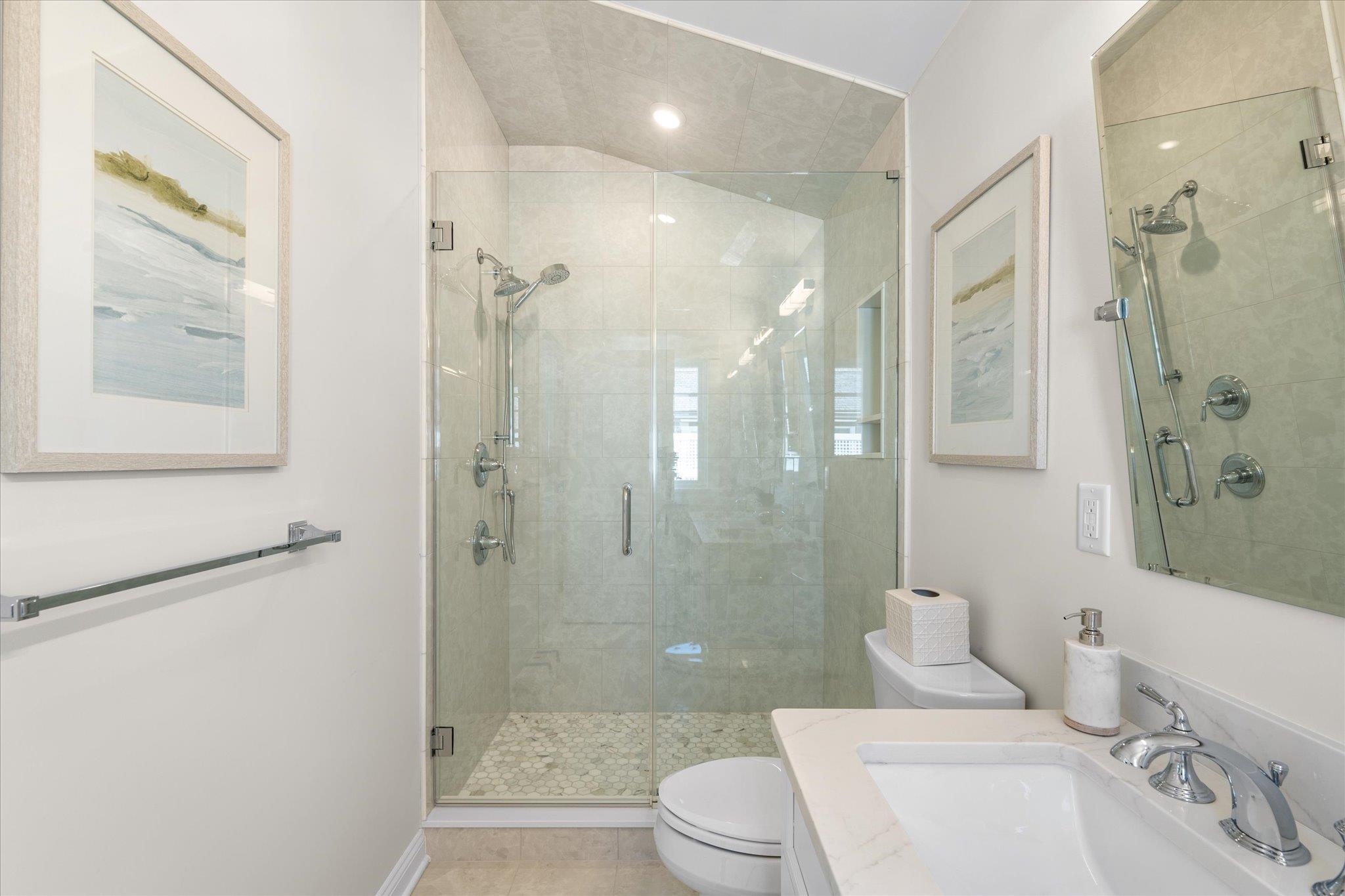10700 3rd, Unit SOUTH Stone Harbor, NJ 08247 - Photo 22 of 30 a bathroom with a toilet a sink a shower and a mirror