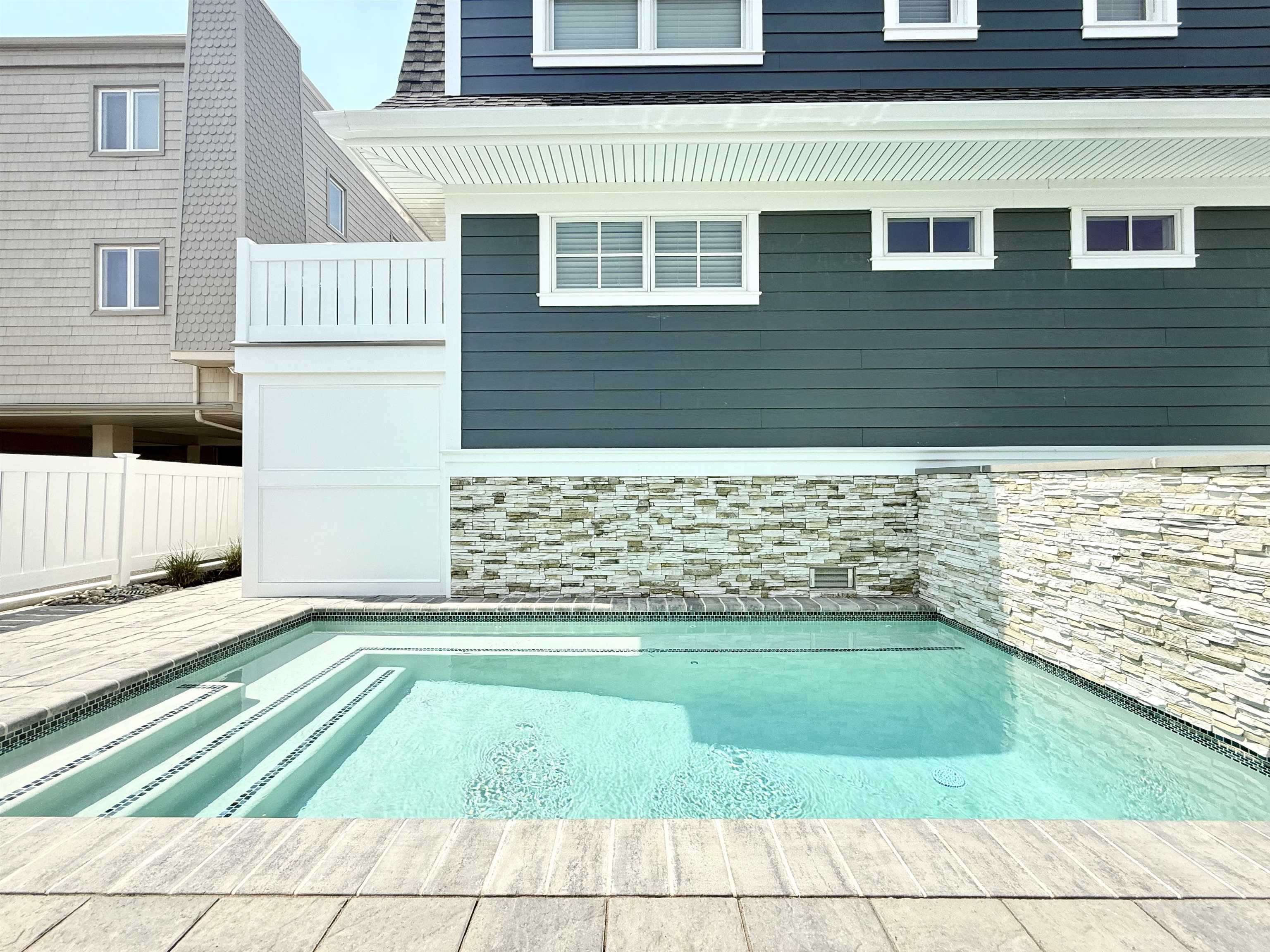 10700 3rd, Unit SOUTH Stone Harbor, NJ 08247 - Photo 24 of 30 a view of a backyard with brick wall