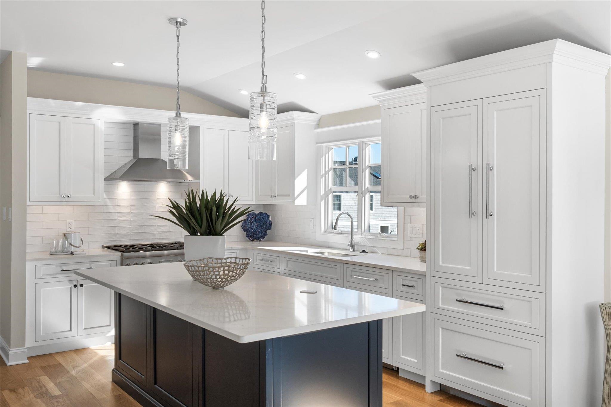 10700 3rd, Unit SOUTH Stone Harbor, NJ 08247 - Photo 9 of 30 a kitchen with kitchen island white cabinets and refrigerator
