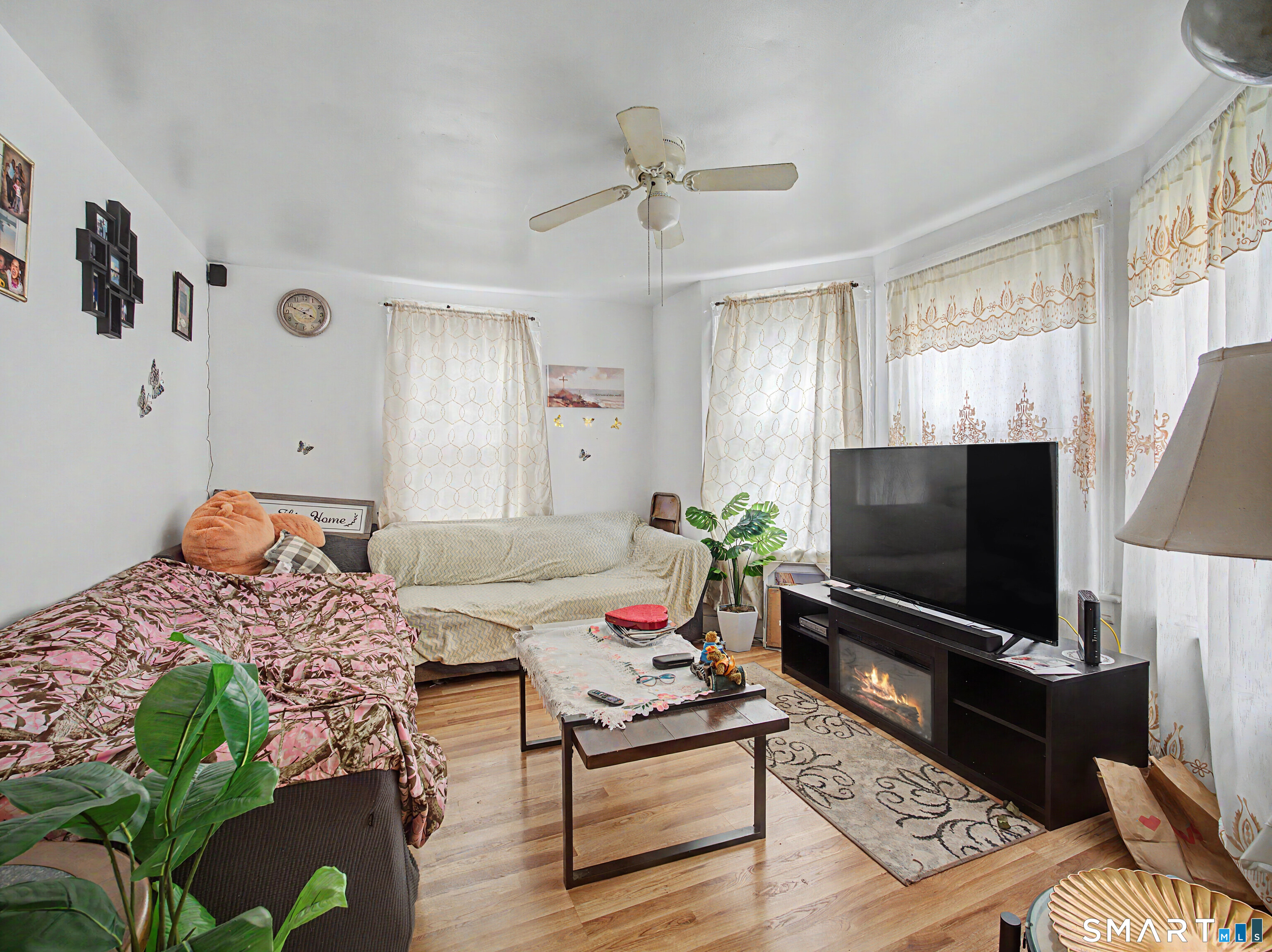 319 Carroll Avenue Bridgeport, CT 06607 - Photo 10 of 40 a living room with furniture and a flat screen tv