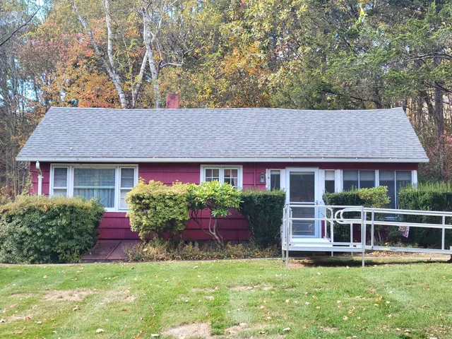 a front view of a house with a yard table and chairs