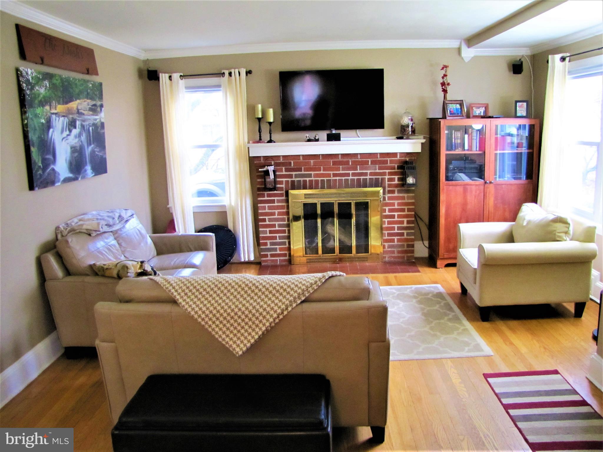 6310 South Orchard Road Linthicum, MD 21090 - Photo 11 of 52 Comfy living room with wood burning fireplace.