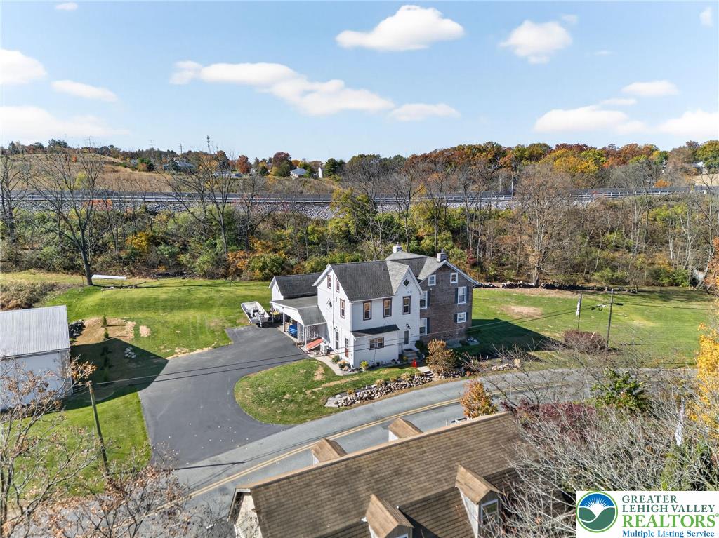 an aerial view of a house with a garden and a mountain view in back