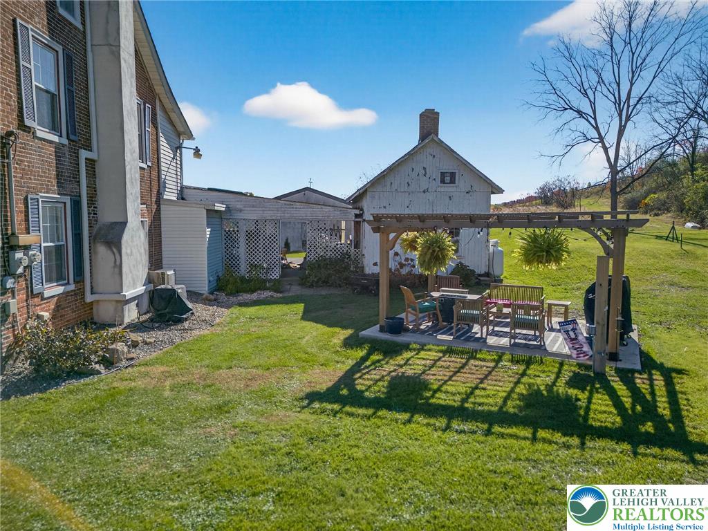 4430 Coplay Creek Road, Unit B Schnecksville, PA 18078 - Photo 22 of 27 a view of a house with a big yard potted plants and large tree