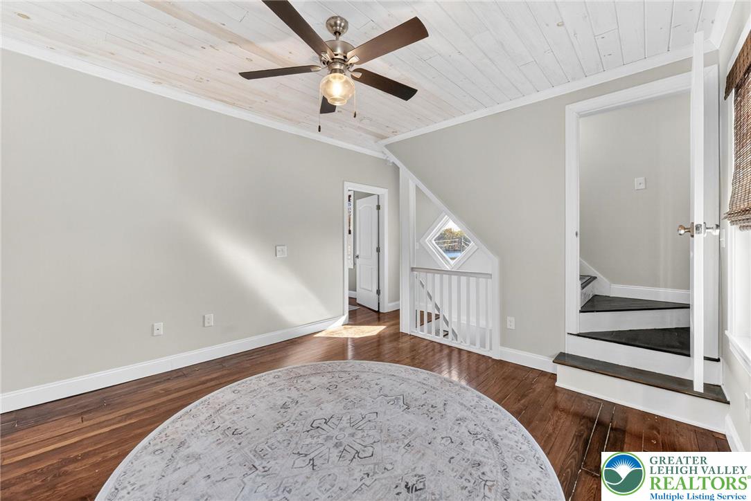 4430 Coplay Creek Road, Unit B Schnecksville, PA 18078 - Photo 4 of 27 an empty room with wooden floor fan and windows