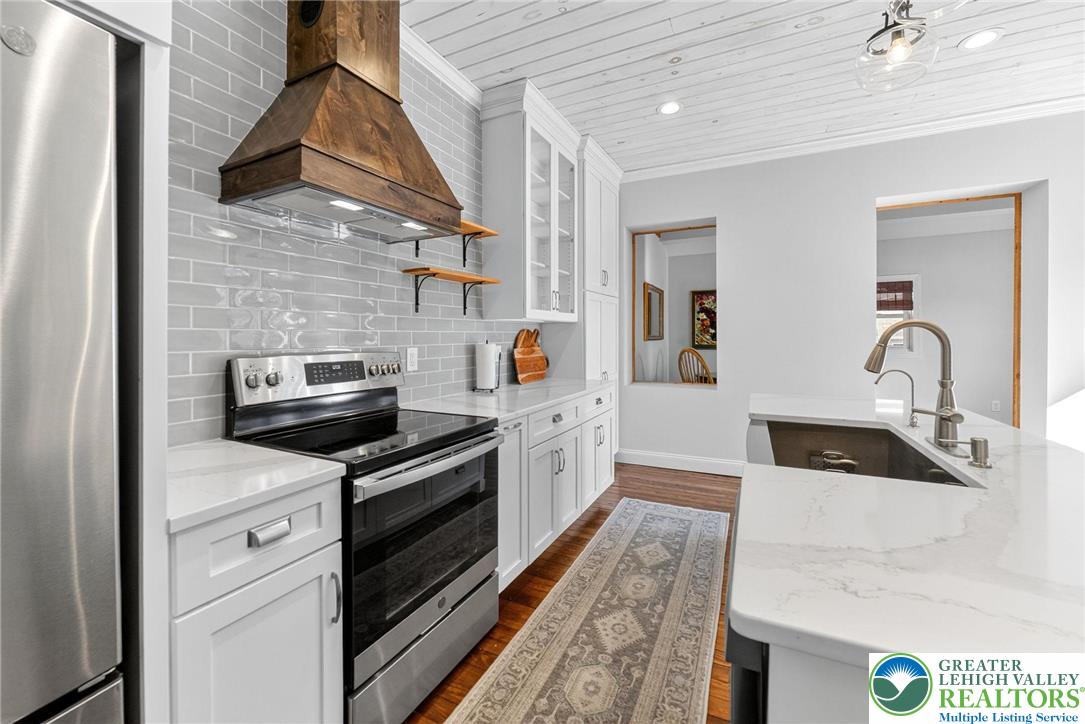 4430 Coplay Creek Road, Unit B Schnecksville, PA 18078 - Photo 7 of 27 a kitchen with stainless steel appliances granite countertop a sink and stove top oven