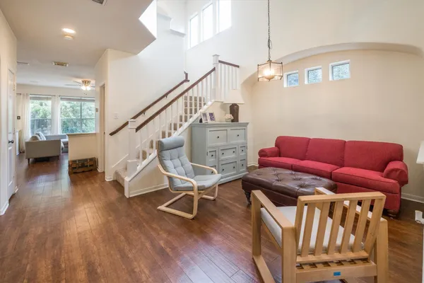 a living room with furniture and a wooden floor