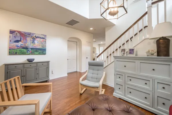 a living room with furniture and wooden floor