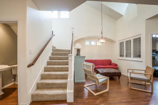 a view of entryway and hall with wooden floor