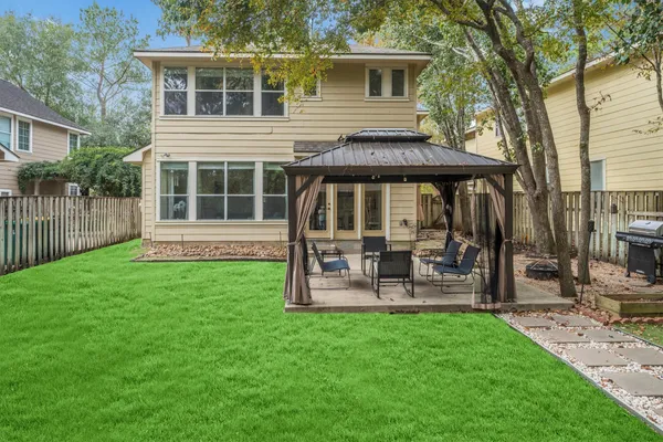 a front view of a house with a yard table and chairs