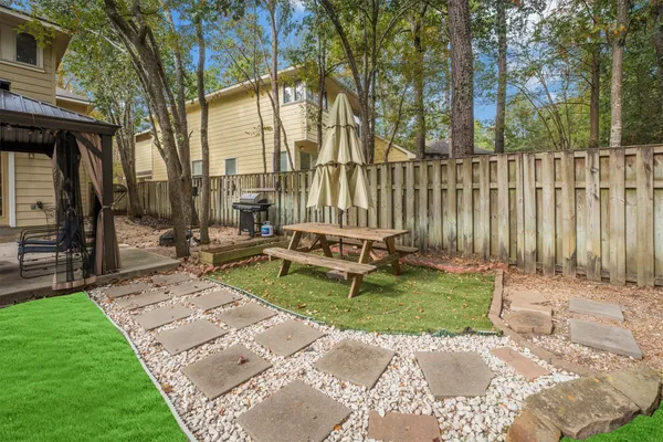 a backyard of a house with table and chairs