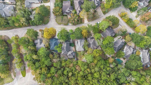 an aerial view of residential house with outdoor space and trees all around
