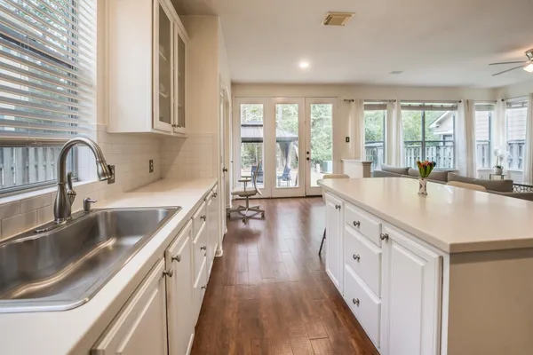 a large kitchen with a sink and cabinets