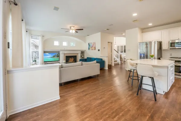 a kitchen with a table chairs refrigerator and cabinets