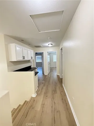 a view of a kitchen with wooden floor