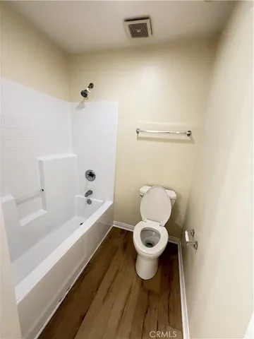 a bathroom with a toilet and a bathtub