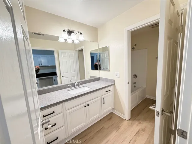 a bathroom with a double vanity sink and a mirror