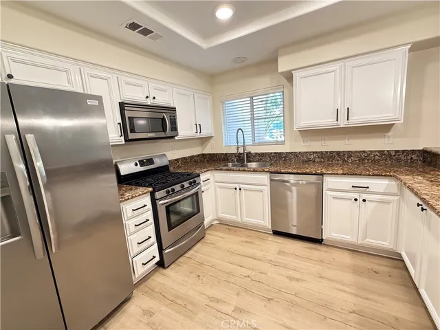 a kitchen with a stove a sink and a microwave