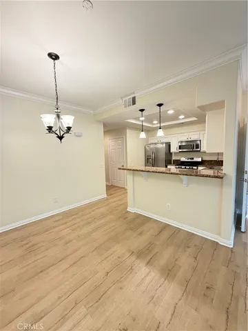 a view of a kitchen with a stove cabinets and a chandelier