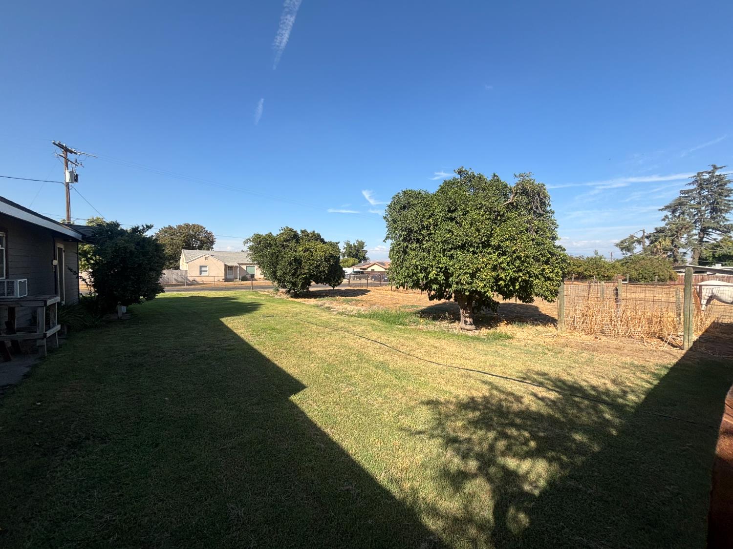19317 East Parlier Avenue Reedley, CA 93654 - Photo 10 of 36 a view of a yard with yellow house