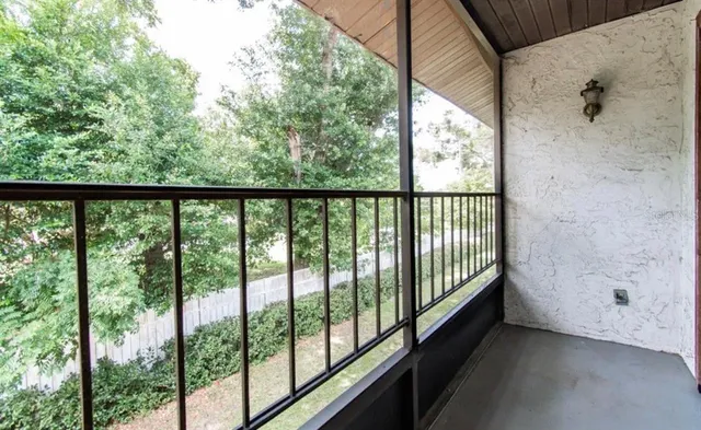 a view of a balcony with furniture