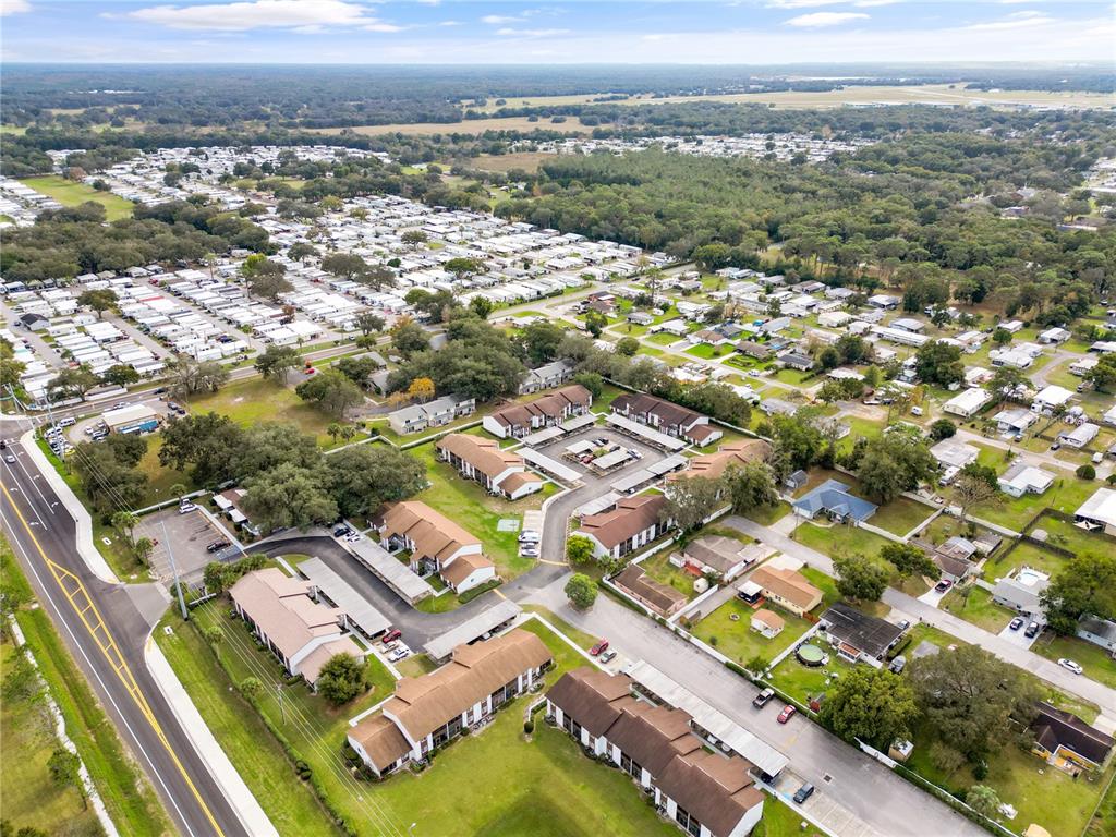 39132 County Road 54, Unit 2180 Zephyrhills, FL 33542 - Photo 16 of 19 an aerial view of residential houses with outdoor space