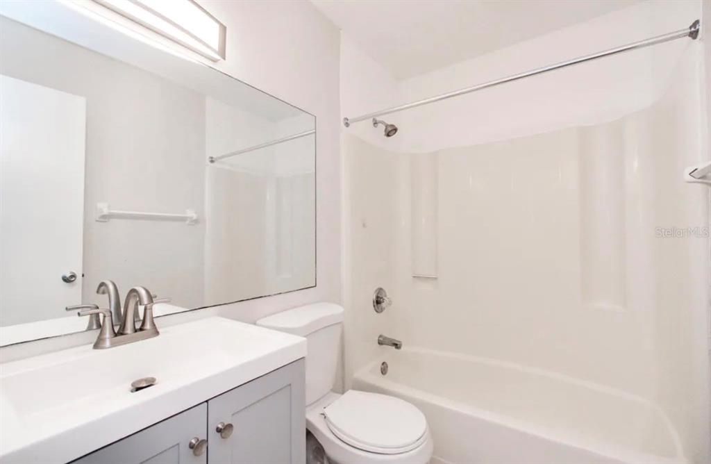 39132 County Road 54, Unit 2180 Zephyrhills, FL 33542 - Photo 7 of 19 a bathroom with a sink toilet and shower