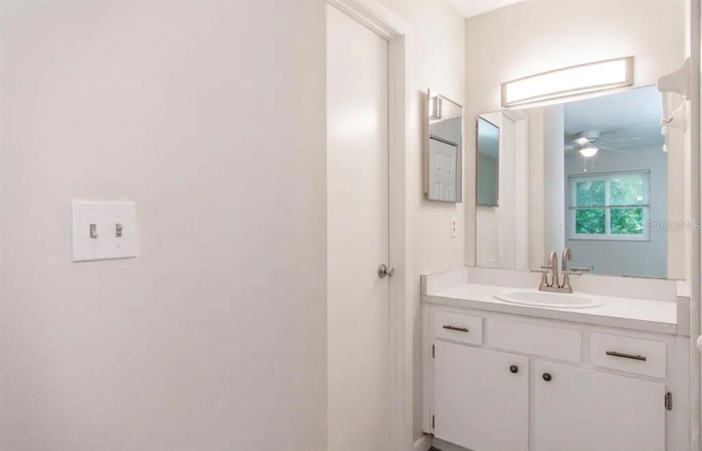 39132 County Road 54, Unit 2180 Zephyrhills, FL 33542 - Photo 9 of 19 a bathroom with a sink and a mirror