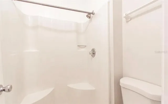 a bathroom with a shower and toilet