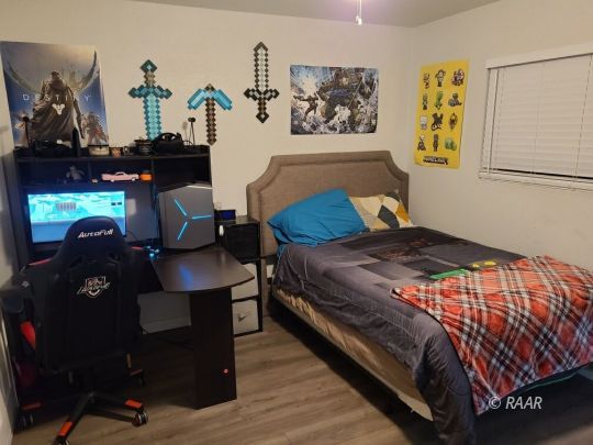 120 South Fire Opal Street Ridgecrest, CA 93555 - Photo 13 of 17 a bedroom with a bed and wooden floor