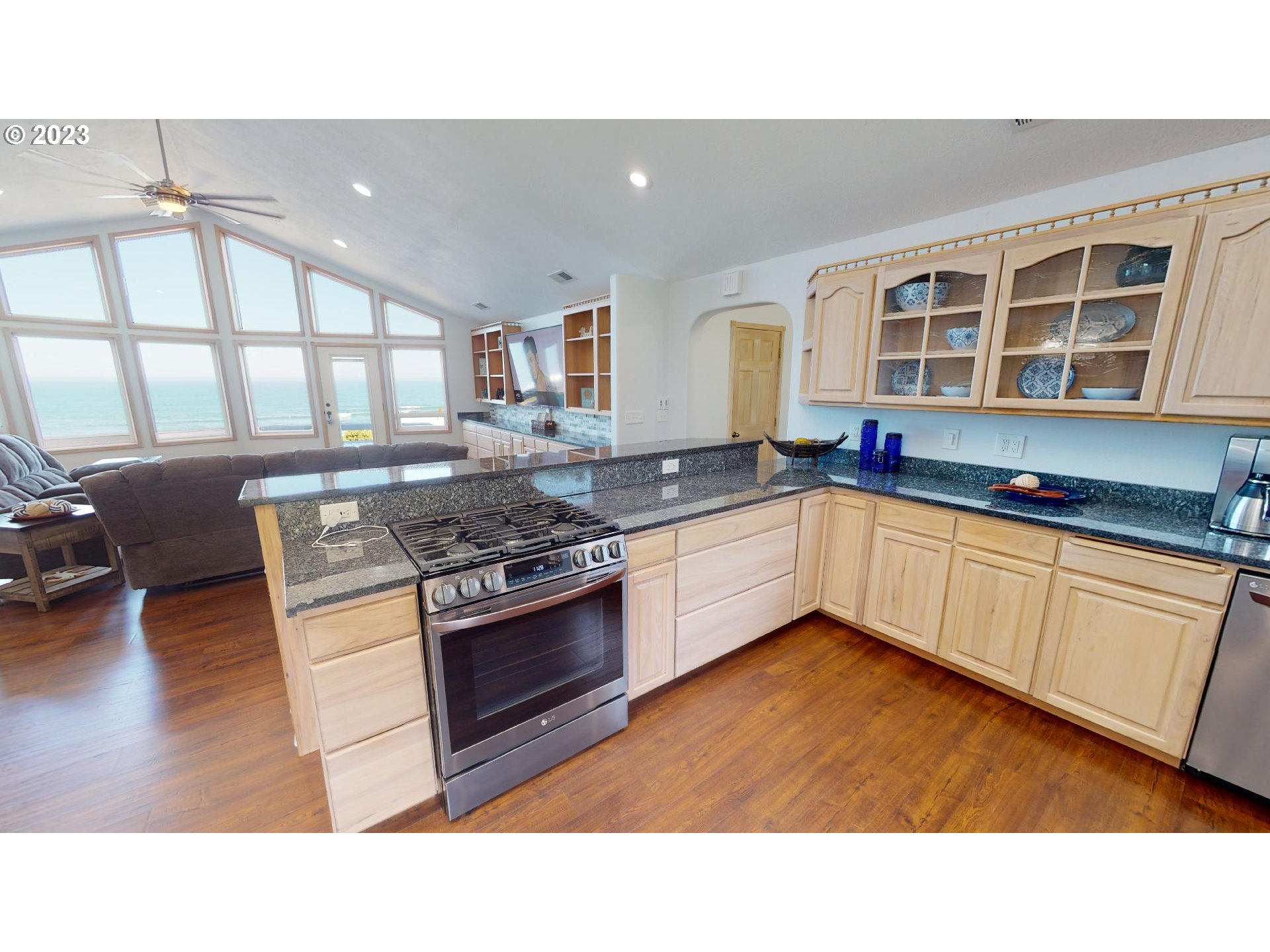 33704 Ophir Road Gold Beach, OR 97444 - Photo 11 of 47 a kitchen with stainless steel appliances granite countertop a stove a sink and a microwave