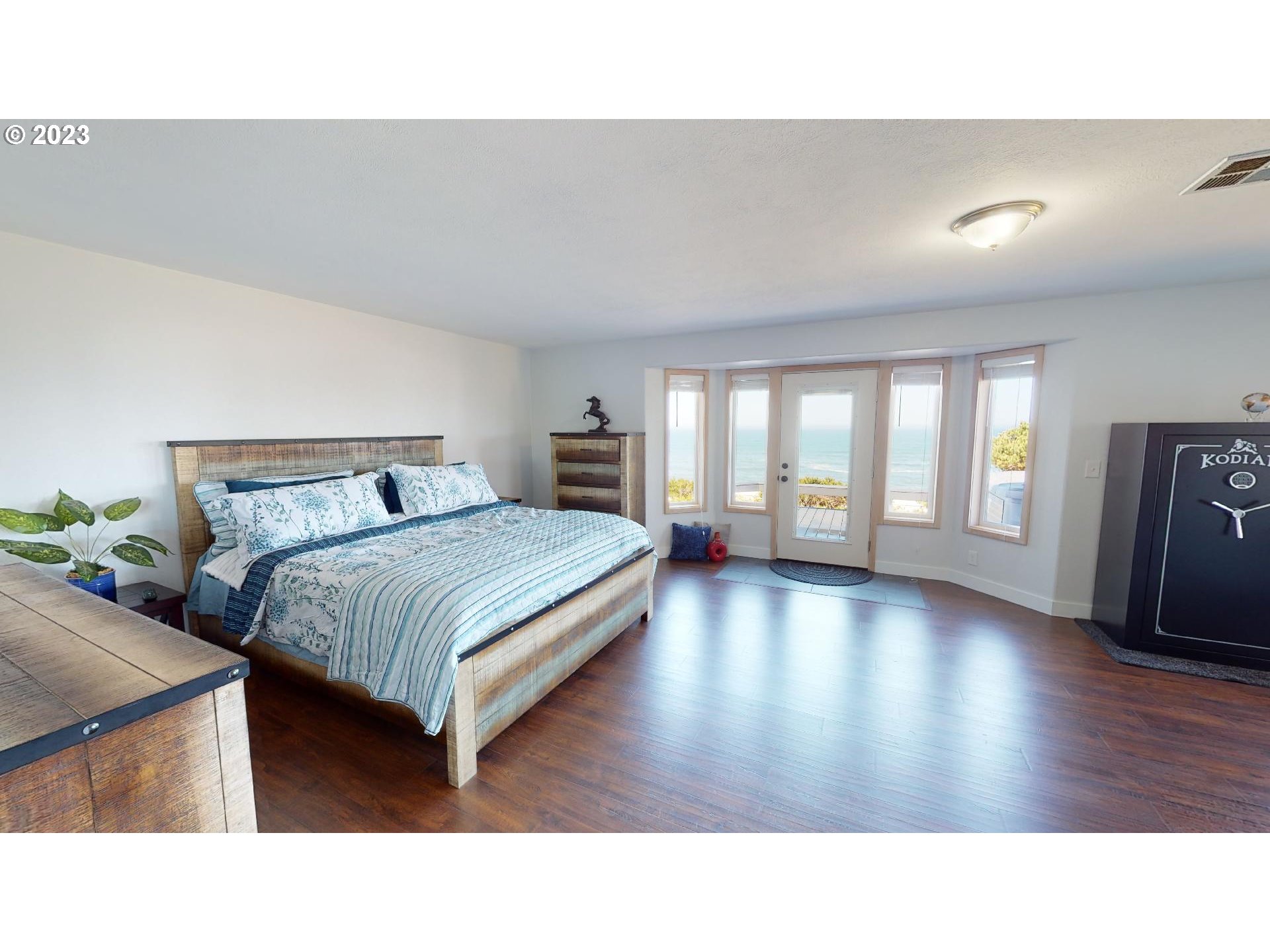 33704 Ophir Road Gold Beach, OR 97444 - Photo 21 of 47 a living room with a bed furniture and a wooden floor