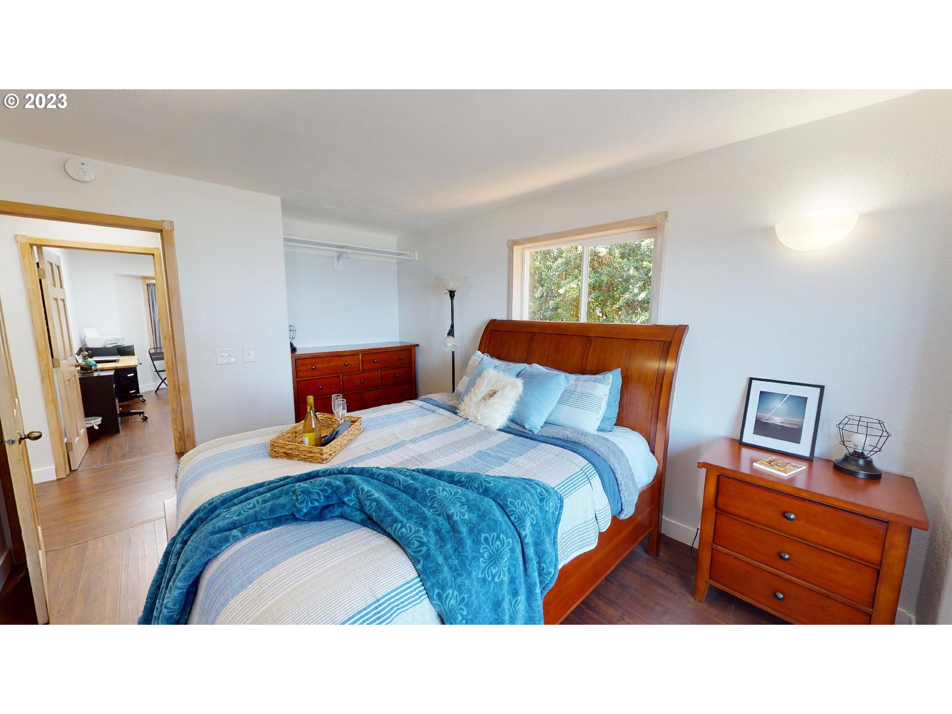 33704 Ophir Road Gold Beach, OR 97444 - Photo 33 of 47 a bedroom with a bed and wooden floor