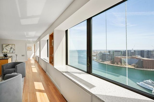 a view of a living room and floor to ceiling window or kitchen
