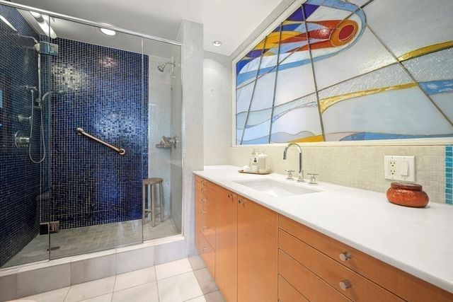 a bedroom with a bed and painting on the wall