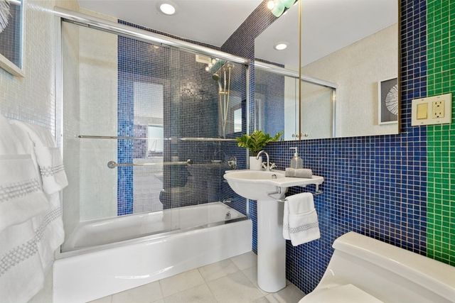 a kitchen with stainless steel appliances kitchen island granite countertop a sink and a granite counter tops