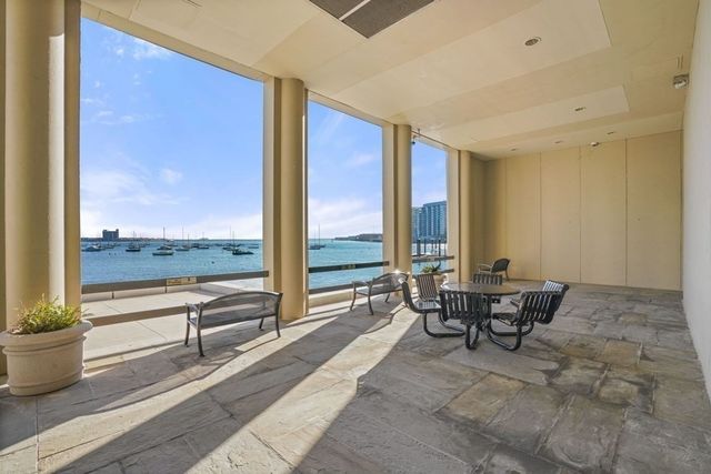 a view of a patio with a table and chairs under an umbrella