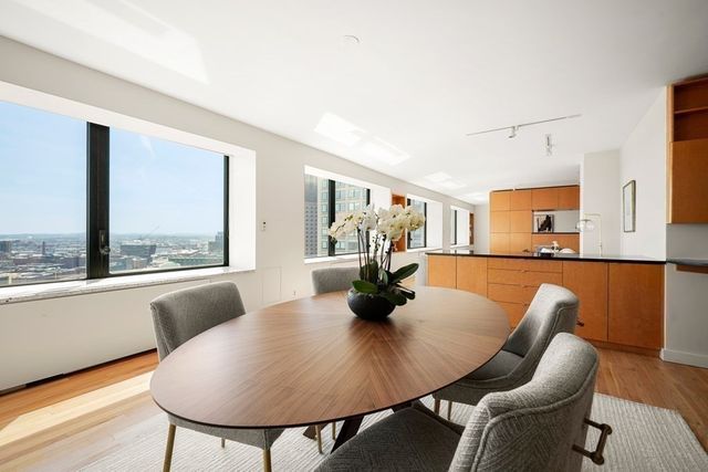 a large kitchen with a table and chairs