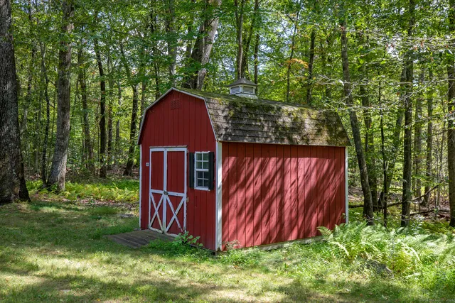 a view of backyard with green space and trampoline