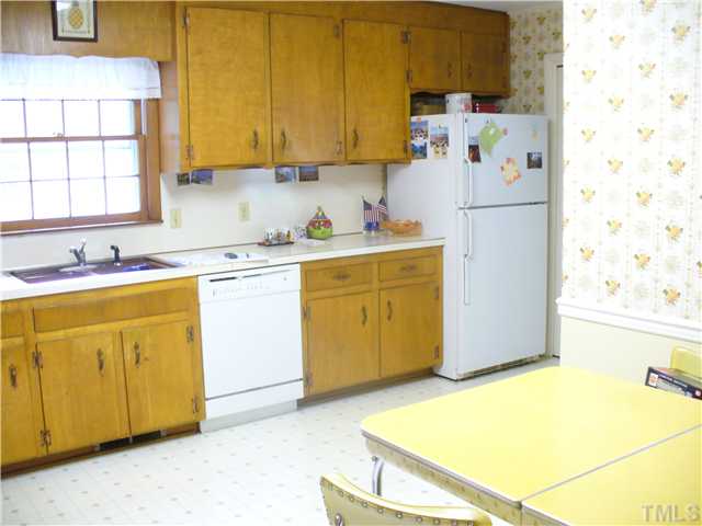 200 Winterlochen Road Raleigh, NC 27603 - Photo 3 of 7 a kitchen with a sink a stove and a refrigerator