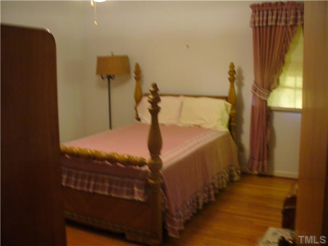 200 Winterlochen Road Raleigh, NC 27603 - Photo 5 of 7 a bedroom with a bed and a window
