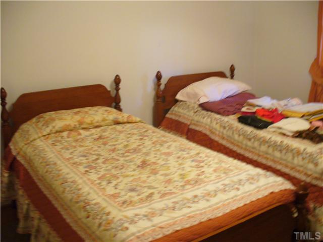 200 Winterlochen Road Raleigh, NC 27603 - Photo 7 of 7 a bedroom with a bed and pillows
