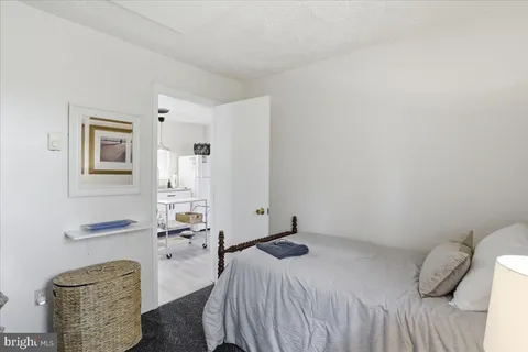 a bedroom with a bed and a couch