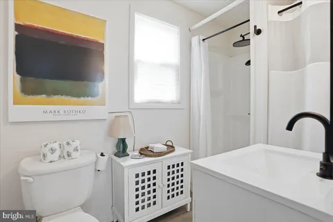 a bathroom with a sink a toilet and a bathtub