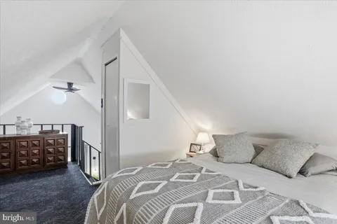 a bed room with a bed window and a night stand