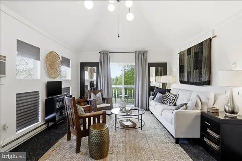 a living room with furniture fireplace and flat screen tv
