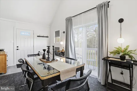 a view of a dining room with furniture and window