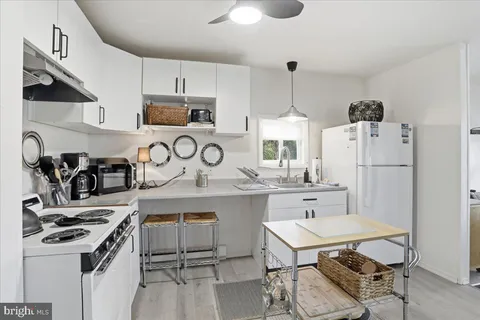 a kitchen with stainless steel appliances a stove a sink and a refrigerator