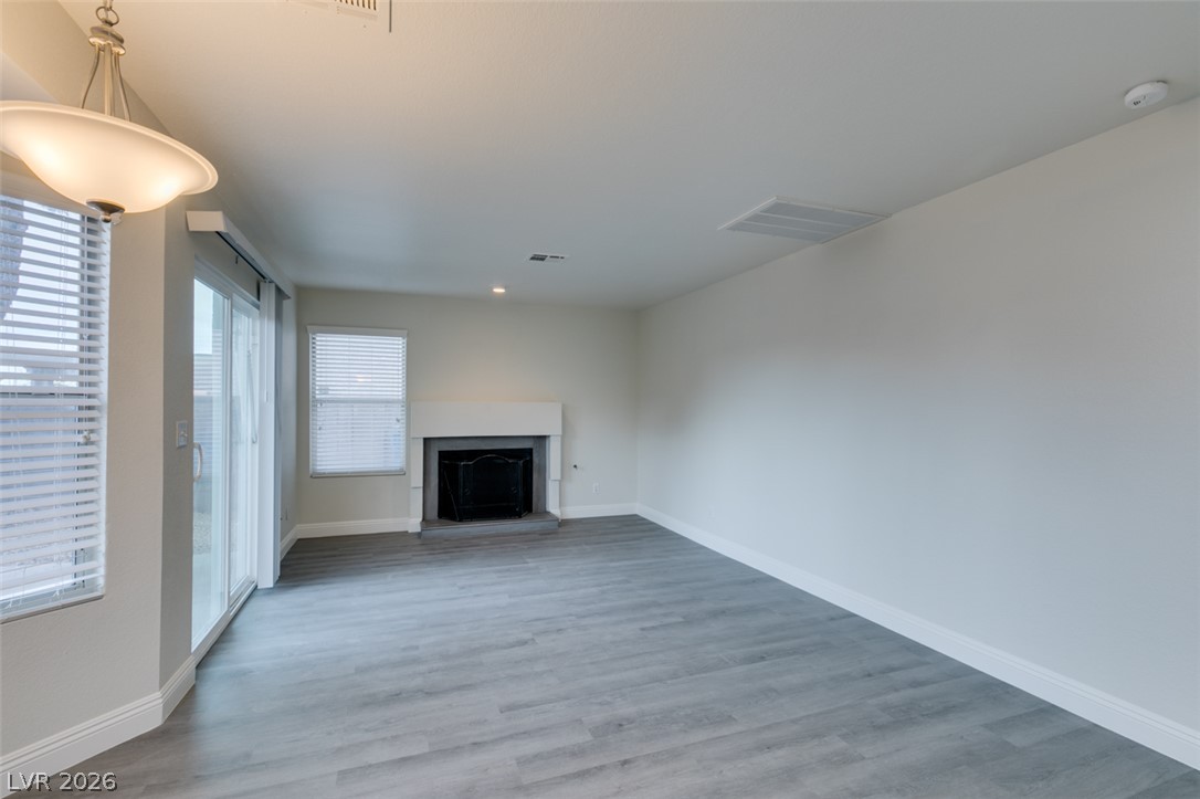 1738 Toltec Circle Henderson, NV 89014 - Photo 16 of 46 Bright, neutral walls and sleek flooring define this inviting living area, centered around a cozy hearth.