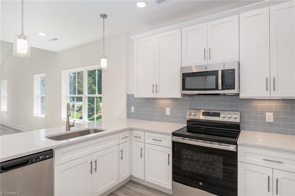 3600 Bridleton Ridge Trail Greensboro, NC 27410 - Photo 3 of 31 Tile backsplash & pendant lighting in kitchen